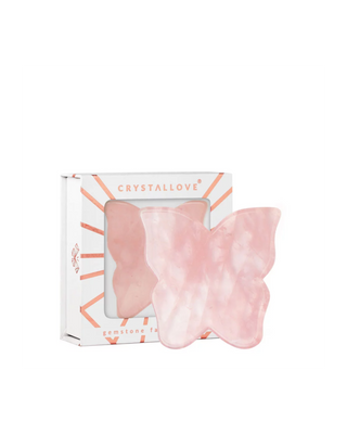 Een vlindervormig gua sha-bordje voor gezichtsmassage van roze kwarts van Crystallove - 1